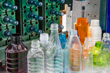 The various type of plastic bottles with injection mold background.