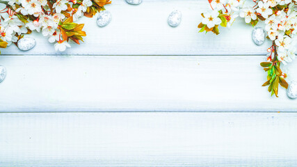Easter flat. Cherry tree blossom, white happy easter eggs on wood spring background. Springtime concept. 