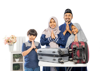 portrait of muslim asian family with suitcase going for eid mubarak holiday