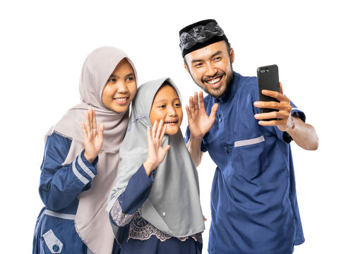 happy muslim family wave to their phone while making a video call and selfie