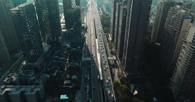 top view of road traffic under the tall buildings at afternoon sunlight
Aerial view of the sunnyl cityscape of modern Chengdu urban area