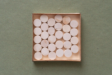shallow box with round wooden objects
