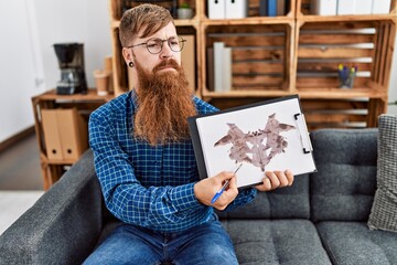 Young redhead man psychology having rorscharch test at clinic