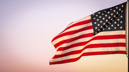 Obraz premium Memorial Day, Independence Day, 4th of July, Veterans Day, Labor Concept. American USA flag waving in the wind against sun flare overlay nature outdoor background, Slow Motion. Concept of Memorial Day