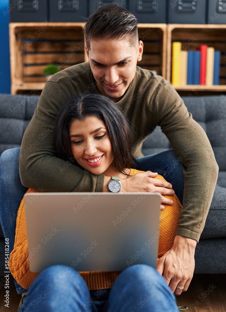 Poster Man and woman couple hugging each other using laptop at home