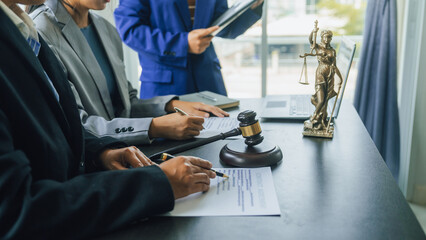 Business lawyer team working with law firms contracts in working room.
