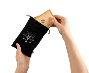 Hands taking tarot cards desk from black small bag isolated on white