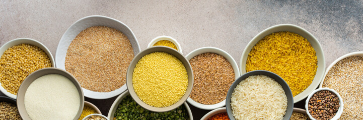 Various grain cereals in bowls banner, top view