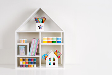 White house shaped shelving with various material for creativity and kids art activity. Stationery...