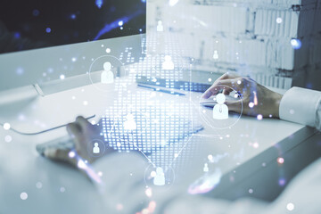 Social network concept with world map and hands typing on laptop on background. Multiexposure