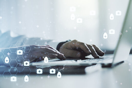 Creative abstract medical hologram and hands typing on computer keyboard on background, online medical consulting concept. Multiexposure