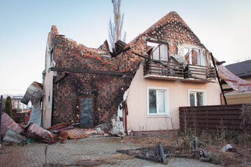 Destroyed building after russian invasion, Ukraine. Ruined facade of house. War in Ukraine. Broken...