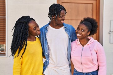 African american friends smiling confident hugging each other at street