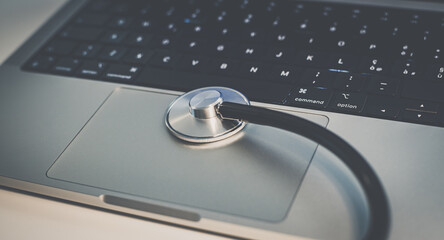 Obraz na płótnie Canvas Stethoscope on laptop keyboard. Health care, remote medical examination. Healthcare business concept