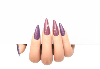 Female hand wih perfect stiletto manicure holding white paper. Template for postcard or advertising...