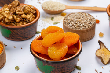 Healthy vegetarian food concept. Assortment of dried fruits, nuts and seeds on white background. Top view.