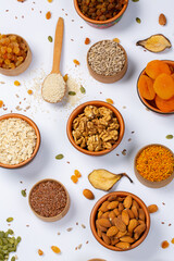 Healthy vegetarian food concept. Assortment of dried fruits, nuts and seeds on white background. Top view.