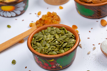 Healthy vegetarian food concept. Assortment of dried fruits, nuts and seeds on white background. Top view.