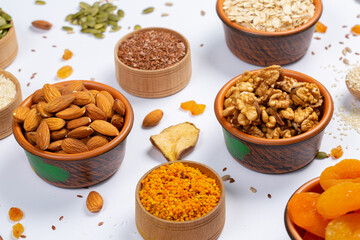 Healthy vegetarian food concept. Assortment of dried fruits, nuts and seeds on white background. Top view.