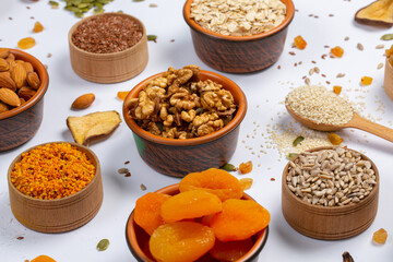 Healthy vegetarian food concept. Assortment of dried fruits, nuts and seeds on white background. Top view.