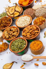 Healthy vegetarian food concept. Assortment of dried fruits, nuts and seeds on white background. Top view.