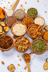 Healthy vegetarian food concept. Assortment of dried fruits, nuts and seeds on white background. Top view.