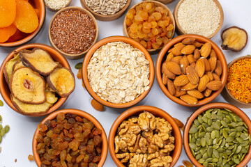 Healthy vegetarian food concept. Assortment of dried fruits, nuts and seeds on white background. Top view.