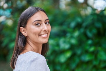 Young beautiful hispanic woman smiling confident standing at park