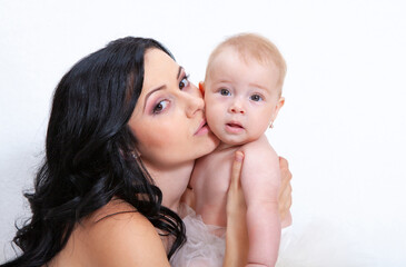 happy mother with baby on a light background
