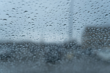 raindrops on a car windsheld in a parking lot