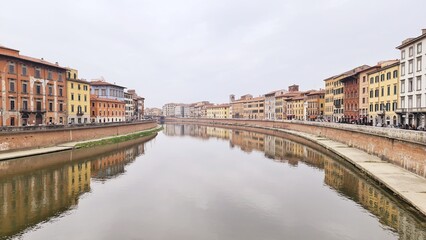 Obraz premium Pisa, Italy - February 25, 2023: View of the medieval town of Pisa from bridge 