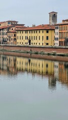 Obraz premium Pisa, Italy - February 25, 2023: View of the medieval town of Pisa from bridge 