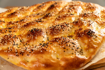 Close up of special Turkish Ramadan Pita pide bread on wooden table