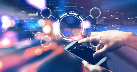 Tech circle with person using a smartphone in a city at night