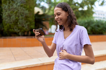 Young african american woman smiling confident watching video on smartphone at park