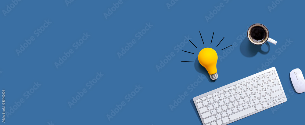 Poster computer keyboard with a yellow light bulb from above