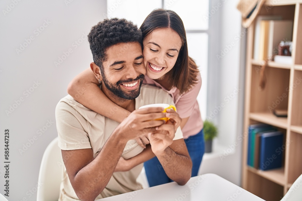 Poster Man and woman couple sitting on table drinking coffee at home