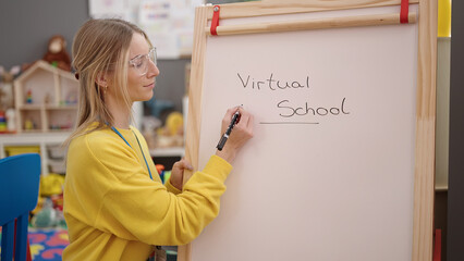 Young blonde woman on a video call working as teacher at kindergarten