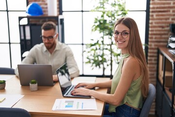 Obraz premium Man and woman business workers using laptop working at office