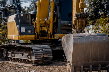 Excavator with shovel digs the ground for the foundation at constuction area.