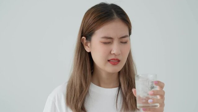 Asian woman feel sensitive teeth after drinking cold, female suffer tooth, decay problems, dental care, tooth extraction, decay problem, bad breath, Gingival Recession, Oral Hygiene instruction