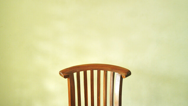 Empty wooden chair brown yellow background