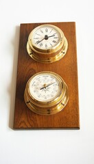 Marine brass barometer and ship clock.