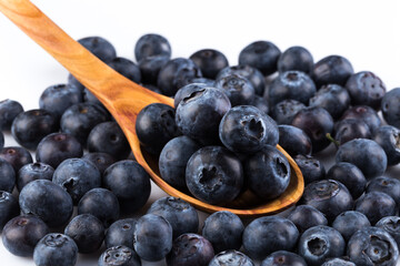 Fresh blueberries in wooden spoon