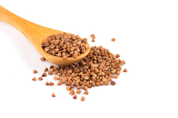 Uncooked buckwheat on wooden spoon