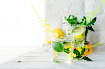 Fresh mojito drinks in bottles and ingredients - lemon and mint