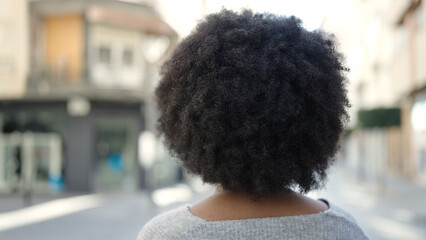 African american woman standing on back view at street