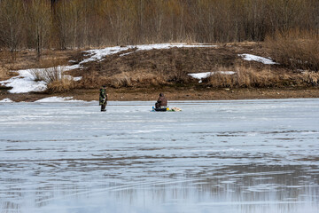 ishermen in the spring catch fish on the lake by ice fishing