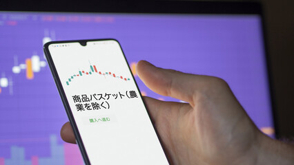 Investor analyzing an ETF. Funds stocks exchange ETFs Japanese text: Goods Basket (Excluding Agriculture), buy. 商品バスケット（農業を除く） 証券取引所 投資 shares