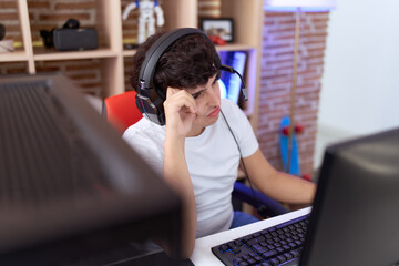 Non binary man streamer stressed using computer at gaming room